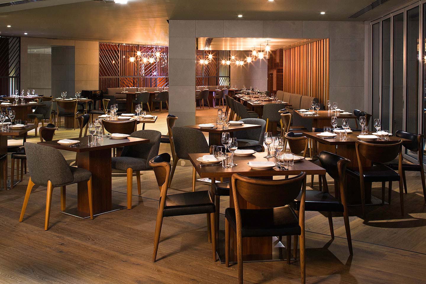 The interior of Marina Social with nicely laid out dining tables and intimate lighting
